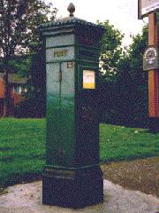 Hexagonal pillar box, painted green.